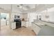 Bright kitchen with white cabinets, appliances, and tiled floor at 9277 St Paul Dr, Port Charlotte, FL 33981