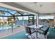 Enclosed lanai featuring ample seating with a view of the pool and waterfront at 9277 St Paul Dr, Port Charlotte, FL 33981