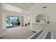 Tranquil bedroom with waterfront view, a fireplace, and access to the patio at 9277 St Paul Dr, Port Charlotte, FL 33981