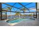 Private pool overlooking the waterfront and surrounded by a screen enclosure and stone deck at 9277 St Paul Dr, Port Charlotte, FL 33981