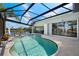 Private pool overlooking the waterfront and surrounded by a screen enclosure and stone deck at 9277 St Paul Dr, Port Charlotte, FL 33981