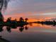 Gorgeous waterfront view with a vibrant sunset reflecting off the water, showcasing the serene neighborhood at 9277 St Paul Dr, Port Charlotte, FL 33981