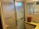 Bathroom featuring a shower with sliding doors, toilet, and tiled walls at 4800 Fleetwood St, New Port Richey, FL 34653