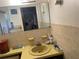 Functional bathroom featuring tiled countertop, cabinets, and mirror; needs updating at 4800 Fleetwood St, New Port Richey, FL 34653