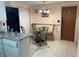 Cozy dining area with a round table, four chairs, and white kitchen cabinets in the background at 4800 Fleetwood St, New Port Richey, FL 34653