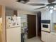Kitchen featuring appliances, white cabinets, pantry and tiled floor at 4800 Fleetwood St, New Port Richey, FL 34653