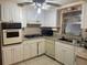 Functional kitchen with white cabinets, countertops, and essential appliances including a gas cooktop at 4800 Fleetwood St, New Port Richey, FL 34653