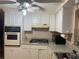Efficient kitchen with white cabinets, gas cooktop, and appliances; bathed in natural light at 4800 Fleetwood St, New Port Richey, FL 34653