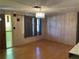 Bright, open living room featuring hardwood flooring, modern lighting, and neutral wall color at 4800 Fleetwood St, New Port Richey, FL 34653