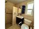 Bathroom features tile shower, modern vanity, commode, shelving and a window at 5428 Nutmeg Ave, Sarasota, FL 34231