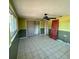 Bedroom features tile flooring, closet with sliding doors, ceiling fan and a window at 5428 Nutmeg Ave, Sarasota, FL 34231