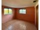 Bedroom featuring tile flooring, two windows, and a closet at 5428 Nutmeg Ave, Sarasota, FL 34231