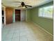 Spacious bedroom featuring tile floors, a ceiling fan, a window and a barn door closet at 5428 Nutmeg Ave, Sarasota, FL 34231