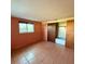 Bedroom features a window, closet with sliding doors and tile flooring at 5428 Nutmeg Ave, Sarasota, FL 34231