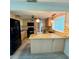 Well-lit kitchen featuring granite countertops, stainless steel appliances, and a breakfast bar at 5428 Nutmeg Ave, Sarasota, FL 34231