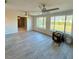 Bright living room with tiled floors, large windows, and ceiling fans at 5428 Nutmeg Ave, Sarasota, FL 34231