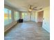 Large, sunny living room with tiled flooring and multiple windows overlooking the backyard at 5428 Nutmeg Ave, Sarasota, FL 34231