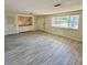 Bright living room with large window, tiled floor, and built in storage at 5428 Nutmeg Ave, Sarasota, FL 34231