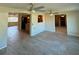 Open floor plan living area with tiled flooring, ceiling fans, and a view to the kitchen at 5428 Nutmeg Ave, Sarasota, FL 34231