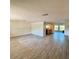 Spacious living room with hard surface flooring and an open floor plan overlooking the kitchen at 5428 Nutmeg Ave, Sarasota, FL 34231