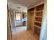 Utility room featuring door to outside, shelving and tile flooring at 5428 Nutmeg Ave, Sarasota, FL 34231