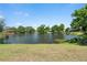 Serene backyard view of a tranquil lake, providing a peaceful setting at 5474 Dominica Cir, Sarasota, FL 34233