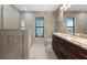 Modern bathroom features a glass-enclosed shower, double vanity, and elegant tile work at 5474 Dominica Cir, Sarasota, FL 34233