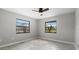 Bright bedroom featuring tile floors, neutral paint and dual windows offering plenty of natural light at 5474 Dominica Cir, Sarasota, FL 34233