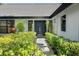 Inviting front entrance with lush landscaping and stylish, modern double doors at 5474 Dominica Cir, Sarasota, FL 34233