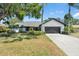 Charming single-story home with mature trees, a well-manicured lawn, and a two-car garage at 5474 Dominica Cir, Sarasota, FL 34233