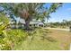 Charming home with mature landscaping and a well-manicured front yard, showcasing curb appeal at 5474 Dominica Cir, Sarasota, FL 34233