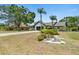 Inviting home featuring a well-maintained lawn and mature trees, creating a welcoming atmosphere at 5474 Dominica Cir, Sarasota, FL 34233