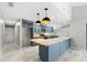 Spacious kitchen with granite counters, sleek appliances, and stylish blue cabinetry and an open layout at 5474 Dominica Cir, Sarasota, FL 34233