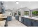 This gorgeous kitchen features granite countertops, blue cabinets and modern stainless appliances at 5474 Dominica Cir, Sarasota, FL 34233