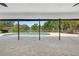 Covered patio offering a view of the pool and lake, perfect for outdoor dining and relaxation at 5474 Dominica Cir, Sarasota, FL 34233