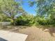 Large backyard with green foliage, bright blue skies, and a small concrete patio space at 923 Brenton Leaf Dr, Ruskin, FL 33570