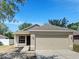 Charming single-Gathering home featuring a two-car garage, neutral paint scheme, and a well-maintained lawn at 923 Brenton Leaf Dr, Ruskin, FL 33570