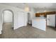Open concept kitchen and dining area with tile floors and arched doorways at 923 Brenton Leaf Dr, Ruskin, FL 33570