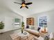 Bright living room features natural light, ceiling fan, and stylish décor, perfect for relaxation and entertaining at 923 Brenton Leaf Dr, Ruskin, FL 33570