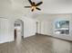 Bright living room with tile floors, ceiling fan, arched doorways, and a window at 923 Brenton Leaf Dr, Ruskin, FL 33570