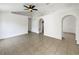 Spacious living room featuring tile flooring, ceiling fan, and arched doorways at 923 Brenton Leaf Dr, Ruskin, FL 33570