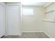 Bedroom featuring plush carpet, natural light from the window, and built-in shelving at 1314 Larsen Ln, Tampa, FL 33619