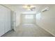 A light-filled bedroom with neutral walls, plush carpeting, ceiling fan, and a double door closet at 1314 Larsen Ln, Tampa, FL 33619