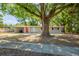 Charming single-story home featuring a welcoming facade, covered parking, and mature shade tree at 1314 Larsen Ln, Tampa, FL 33619