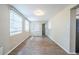 Living room featuring hardwood flooring and large windows with blinds at 1314 Larsen Ln, Tampa, FL 33619