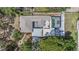 Birds eye view of home showcasing the pool, roof, and well maintained surrounding landscape at 4925 Alcazar S Way, St Petersburg, FL 33712