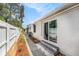 Backyard exterior with stone pathway, sliding glass doors, and well manicured landscaping at 4925 Alcazar S Way, St Petersburg, FL 33712