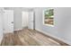 Bedroom featuring hardwood floors and a window offering a view of the neighborhood at 4925 Alcazar S Way, St Petersburg, FL 33712