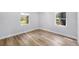 Bright bedroom with hardwood floors and windows offering a view of the neighborhood at 4925 Alcazar S Way, St Petersburg, FL 33712