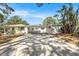 Charming single-story home featuring a spacious driveway and an open carport with landscaping at 4925 Alcazar S Way, St Petersburg, FL 33712